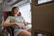 © Aleksej - Woman sleeping in comfortable sleeper bus seat during long distance travel in Southeast Asia transportation interior
