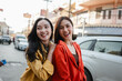 © Parichat - Asian women friends smiling enjoying city travel together