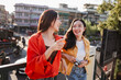 © Parichat - Young Asian women friends traveling talking laughing together