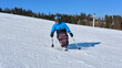 © Alex - A wheelchair user makes a turn on a snowy slope