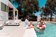 © PintoArt - Family enjoying summer vacation day by swimming pool