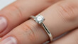 © Sonya - Close-up of a diamond solitaire ring on a finger