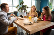 © Viacheslav Yakobchuk - Father, mother, and daughter having a family meal, engaging in conversation