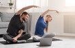 © Prostock-studio - Online sport training. Active couple exercising with internet course at home