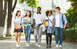 © Prostock-studio - Students communication. Group of college friends walking outdoors in university campus, resting after classes, chatting and laughing, free space