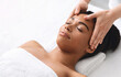 © Prostock-studio - High angle view of black lady having relaxing head massage at spa salon, copy space