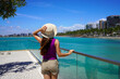 © zigres - Holidays in Brazil. Young woman strolling on promendae in Maceio, Alagoas, Brazil.