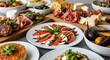 © joo - Variety of gourmet dishes with cheese meat and vegetables on a table