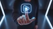 © Hikmat Ullah  - hand touching glowing digital play button icon for streaming and video content concept