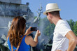 © auremar - woman taking picture of fountain