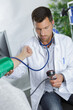 © auremar - doctor measures the blood pressure in patients