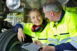 © auremar - portrait of airport workers inspecting aircraft