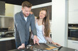 © auremar - couple choosing kitchen design from samples