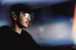 © Cavan - Young man using computer with led cyber glasses, reality headset