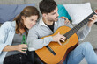 © auremar - lovely young couple playing guitar at home
