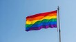 © Ehtisham - Rainbow flag waving against a clear blue sky