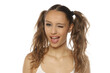 © vladimirfloyd - Studio shot of a playful young woman with wavy pigtails winking on a white background