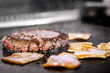 © Ivi - Powerlightss - Angus beef burger patty grilling with sizzling bacon