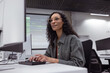 © ReeldealHD images - Confident woman coding at a tech workspace setup