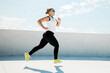 © muse studio - Runner enjoys outdoor exercise on a sunny day at a rooftop location with clear blue skies