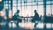 © Heri_s99 - Business meeting silhouette, two men talking at table with laptop, modern office interior, city view