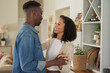 © mavoimages - Loving young multiracial couple dancing hand in hand together at home