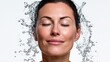 © Nataliia_Trushchenko - A woman is standing in a spray of water, smiling. The water droplets are falling on her face, creating a refreshing and invigorating atmosphere. Concept of joy and relaxation