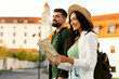 © Home-stock - Man and woman tourists exploring historic area, lady checking map, couple enjoying their travel experience