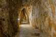 © johnkruger1 - A path carved into the rock leading to Torrent de Pareis in Mallorca. A narrow, scenic trail surrounded by steep cliffs and rugged mountain landscape, offering spectacular views and a unique hiking ex