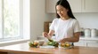 © Running opossum - young asian woman preparing healthy salad in modern kitchen with natural light and cheerful mood