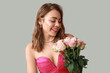 © Pixel-Shot - Young woman with roses on light background. Valentine's Day celebration