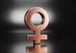 © Ruman - copper female symbol on reflective surface