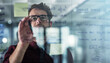 © JamPacked/peopleimages.com - Glass wall, planning and sticky notes with business man in office for brainstorming or strategy. Creative, storyboard and window with design employee in workplace for agenda, schedule or workflow
