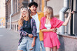 © halayalex - Group of young three stylish friends posing in the street. Fashion man and two cute female dressed in casual summer clothes. Smiling models having fun. Cheerful women and guy outdoors