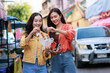 © Phimwilai - Young asian women travelers enjoying street food together