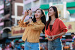 © Phimwilai - Young asian women traveling enjoying city exploration activity