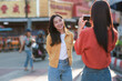 © Phimwilai - Young asian friends capturing happy travel memories on street