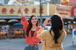 © Phimwilai - Asian friends enjoying city travel taking pictures