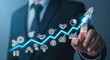 © salam - Businessman Touching Glowing Growth Chart with Business Icons.