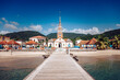 © Travel 'n' Lifestyle - View of a charming church steeple rises above the quaint town, vibrant beach, and inviting boardwalk in the coastal paradise, Les Anses-d'Arlet, Martinique.