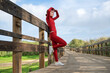 © Rob Wilkinson - sporty woman runner resting leaning on a railing on a boardwalk after exercise