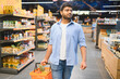 © Serhii - Indian man shopping for groceries in supermarket with pineapple