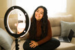 © AntonioDiaz - Woman vlogging with smartphone and ring light, filming content for social media, influencer lifestyle