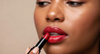 © StudioAi - A close-up shot of a person applying vibrant red lipstick, highlighting glossy lips and flawless skin against a neutral background.