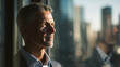 © Katerina - Confident ceo standing by a window overlooking the city at sunset, thoughtful business leader reflecting on success and future growth