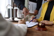 © Wasan - Lawyers and clients engaging in discussions while signing contracts in an office, the importance of legal advice and expertise in corporate law matters.