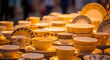 © Mehenara - Assorted yellow ceramic tableware arranged neatly on display, warm and inviting with soft lighting