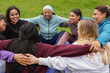 © Sabrina - Women circle meeting each other and doing group meditation at city park - Multi generational people, yoga and international community concept