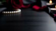 © Yuliia - Romantic dark wooden surface with red roses, pearl necklace and candles creating elegant Valentine's Day or anniversary atmosphere for luxury product display.