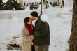 © BGStock72 - Korean woman and Caucasian man sharing a moment in the snow during winter afternoon